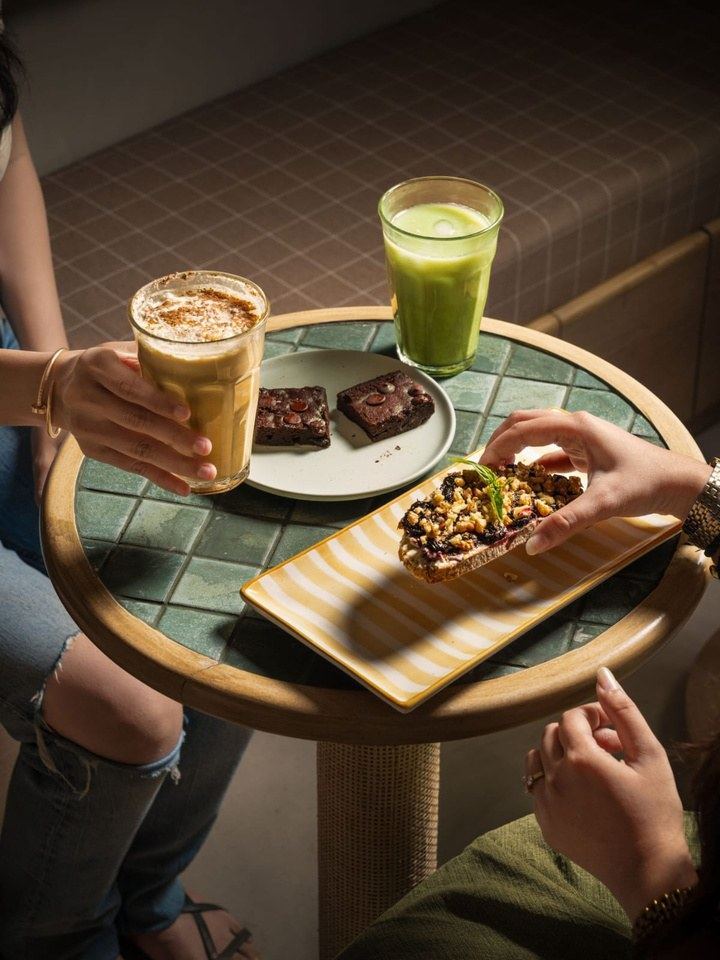 Table with lattes, brownies and toast at Kemps Corner, Mumbai
